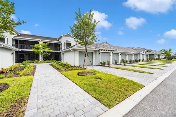 a front view of a house with a yard outdoor seating and flowers