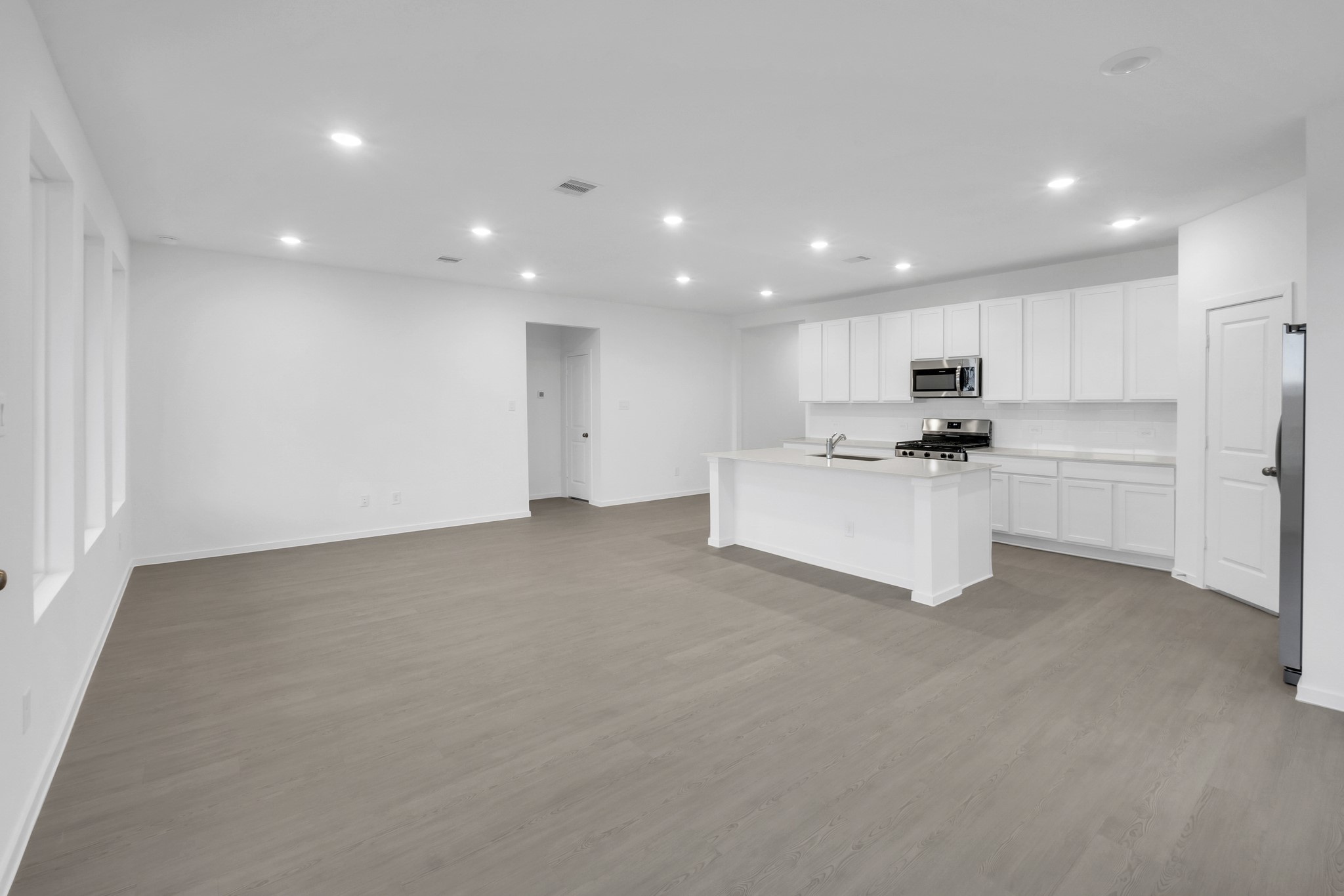 2502 Jasper Breeze Drive Rosharon, TX 77583 - Photo 3 of 21 a view of kitchen with refrigerator sink and wooden floor