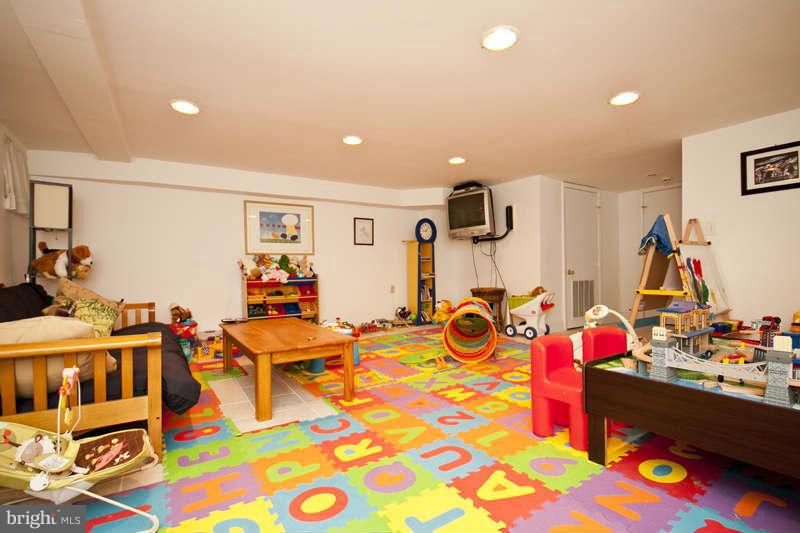 416 Hopkins Road Baltimore, MD 21212 - Photo 11 of 30 a room with lots of white furniture and gym equipment
