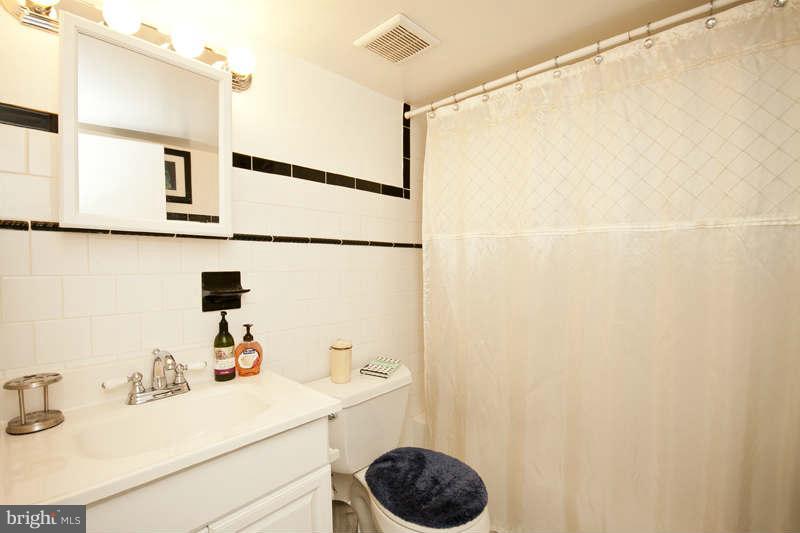 416 Hopkins Road Baltimore, MD 21212 - Photo 13 of 30 a bathroom with a sink and a mirror