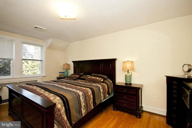 416 Hopkins Road Baltimore, MD 21212 - Photo 14 of 30 a bedroom with a bed and a tv