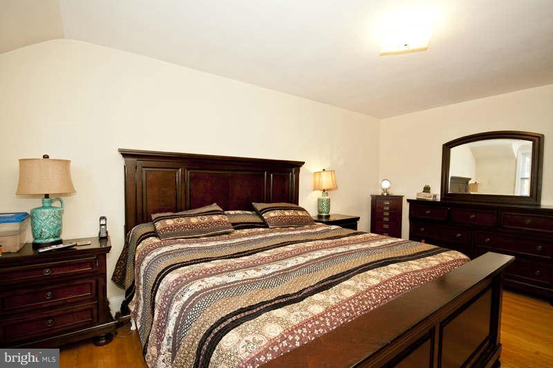 416 Hopkins Road Baltimore, MD 21212 - Photo 15 of 30 a bedroom with a bed and a dresser