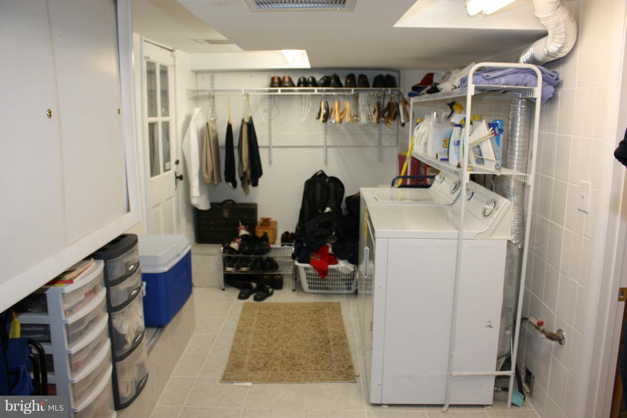 416 Hopkins Road Baltimore, MD 21212 - Photo 25 of 30 a view of walk in closet with clothes and shoes