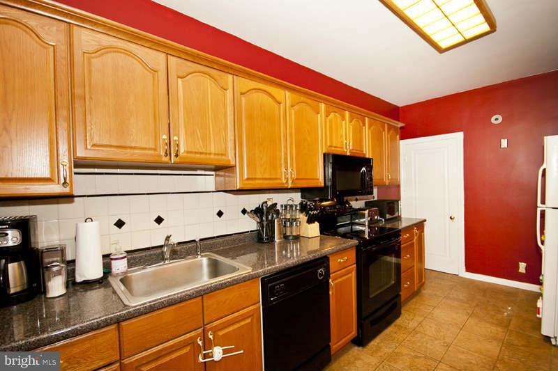 416 Hopkins Road Baltimore, MD 21212 - Photo 7 of 30 a kitchen with stainless steel appliances granite countertop a sink stove and refrigerator