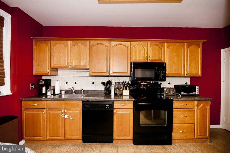 416 Hopkins Road Baltimore, MD 21212 - Photo 8 of 30 a kitchen with stainless steel appliances granite countertop a stove a sink and a microwave