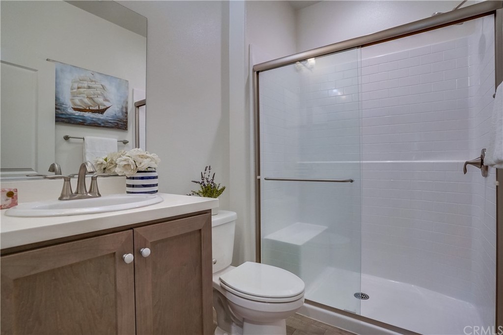 8257 Bella Rosa Drive Rosemead, CA 91770 - Photo 16 of 32 a bathroom with a sink a mirror a toilet and shower