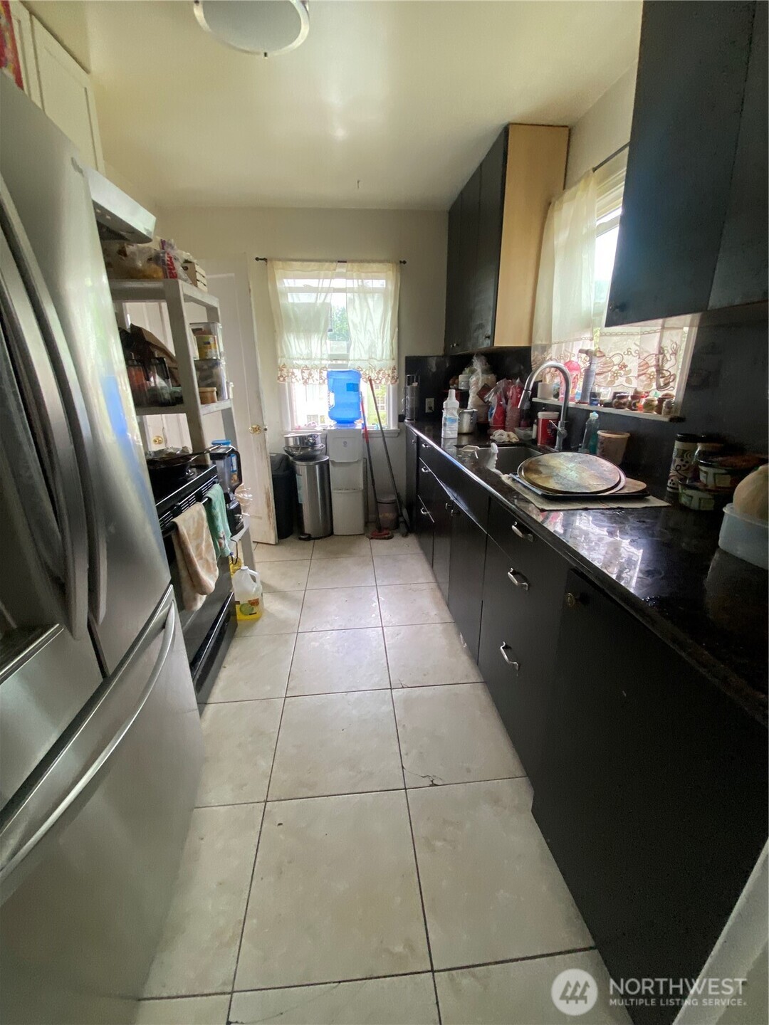 3625 15th Avenue South Seattle, WA 98144 - Photo 2 of 10 a kitchen with stainless steel appliances a sink stove and cabinets