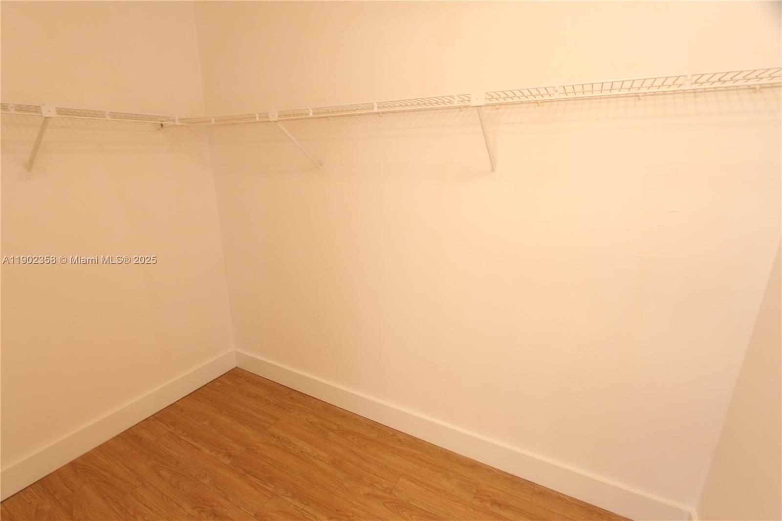 8540 Southwest 212th Street, Unit 203 Cutler Bay, FL 33189 - Photo 18 of 29 a view of a room with an empty walk in closet