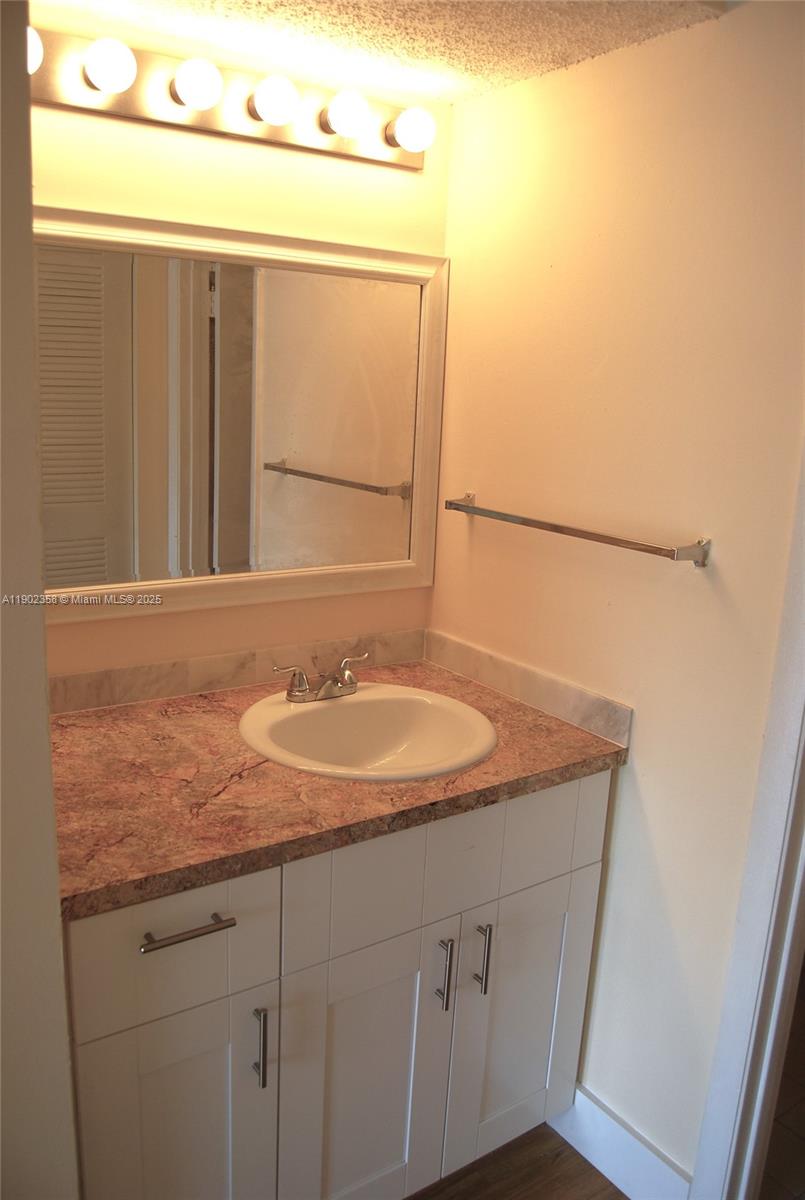 8540 Southwest 212th Street, Unit 203 Cutler Bay, FL 33189 - Photo 20 of 29 a bathroom with a sink and mirror