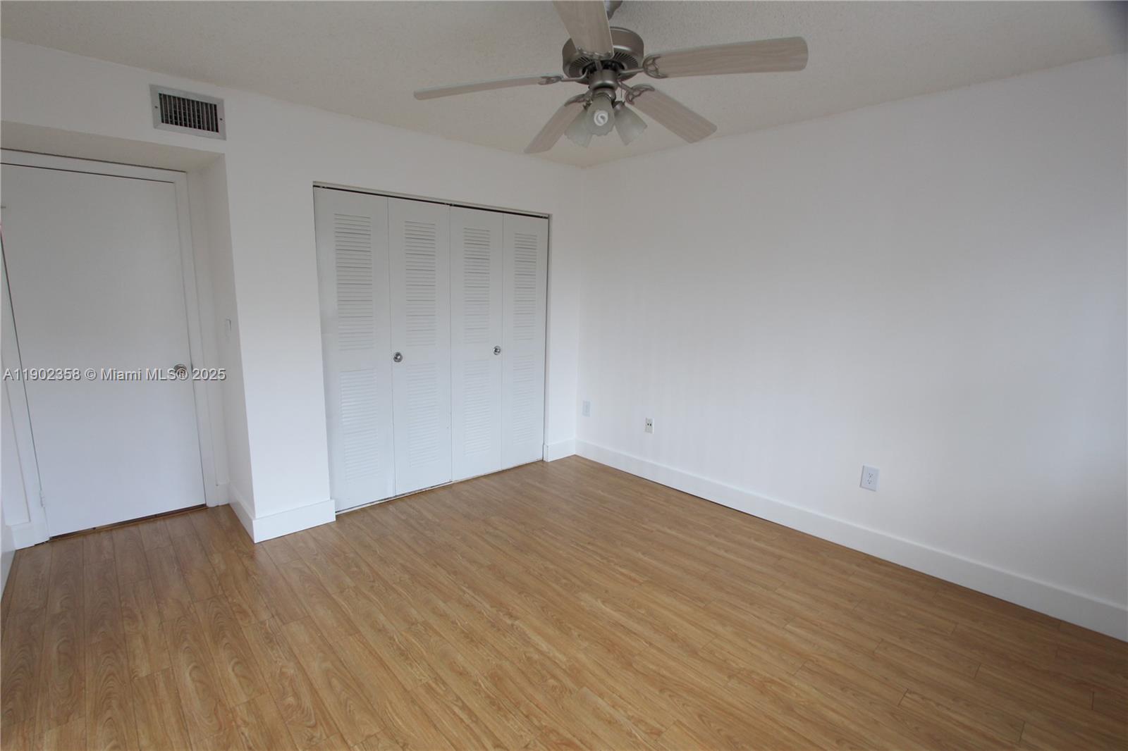 8540 Southwest 212th Street, Unit 203 Cutler Bay, FL 33189 - Photo 23 of 29 a view of empty room with wooden floor