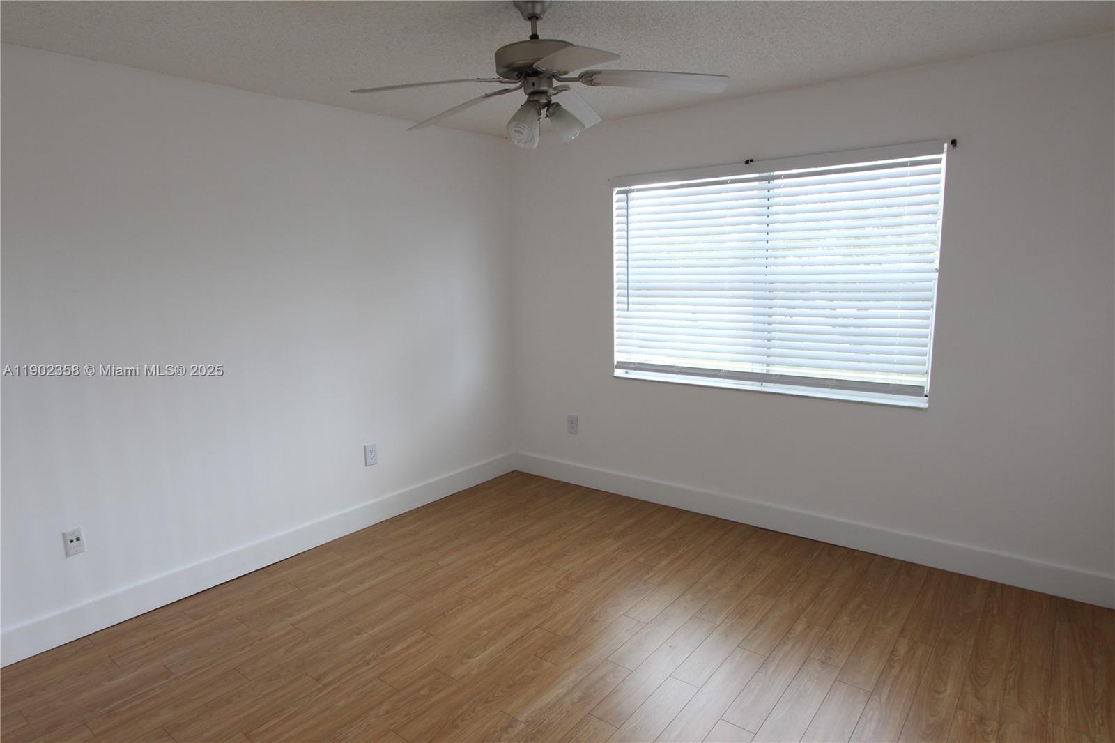 8540 Southwest 212th Street, Unit 203 Cutler Bay, FL 33189 - Photo 24 of 29 an empty room with a window