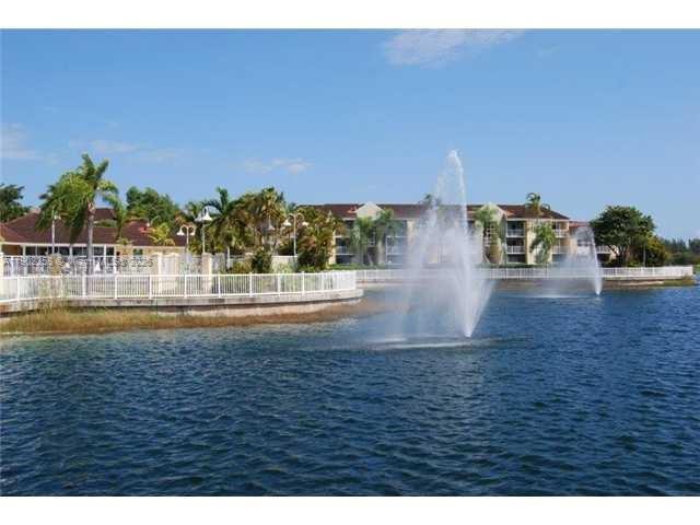 8540 Southwest 212th Street, Unit 203 Cutler Bay, FL 33189 - Photo 28 of 29 a view of building and car parked