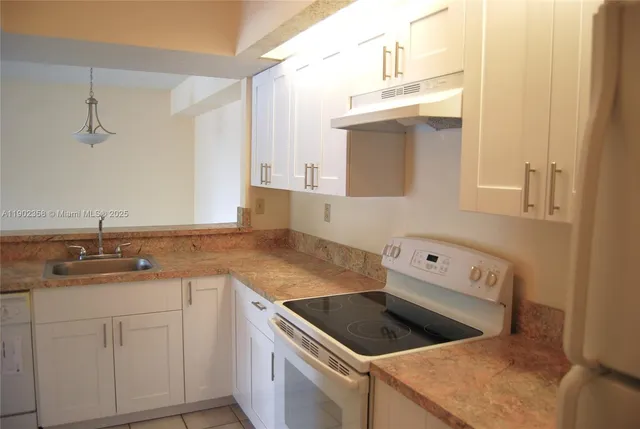 a kitchen that has a sink and a stove