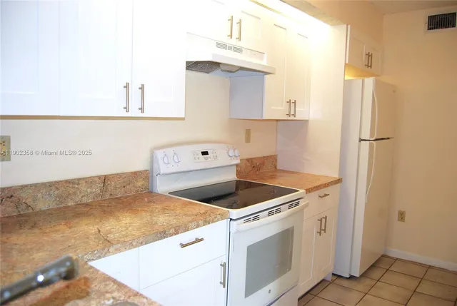 a kitchen that has a sink and a stove