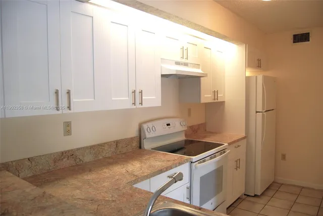 a kitchen that has a sink and a stove