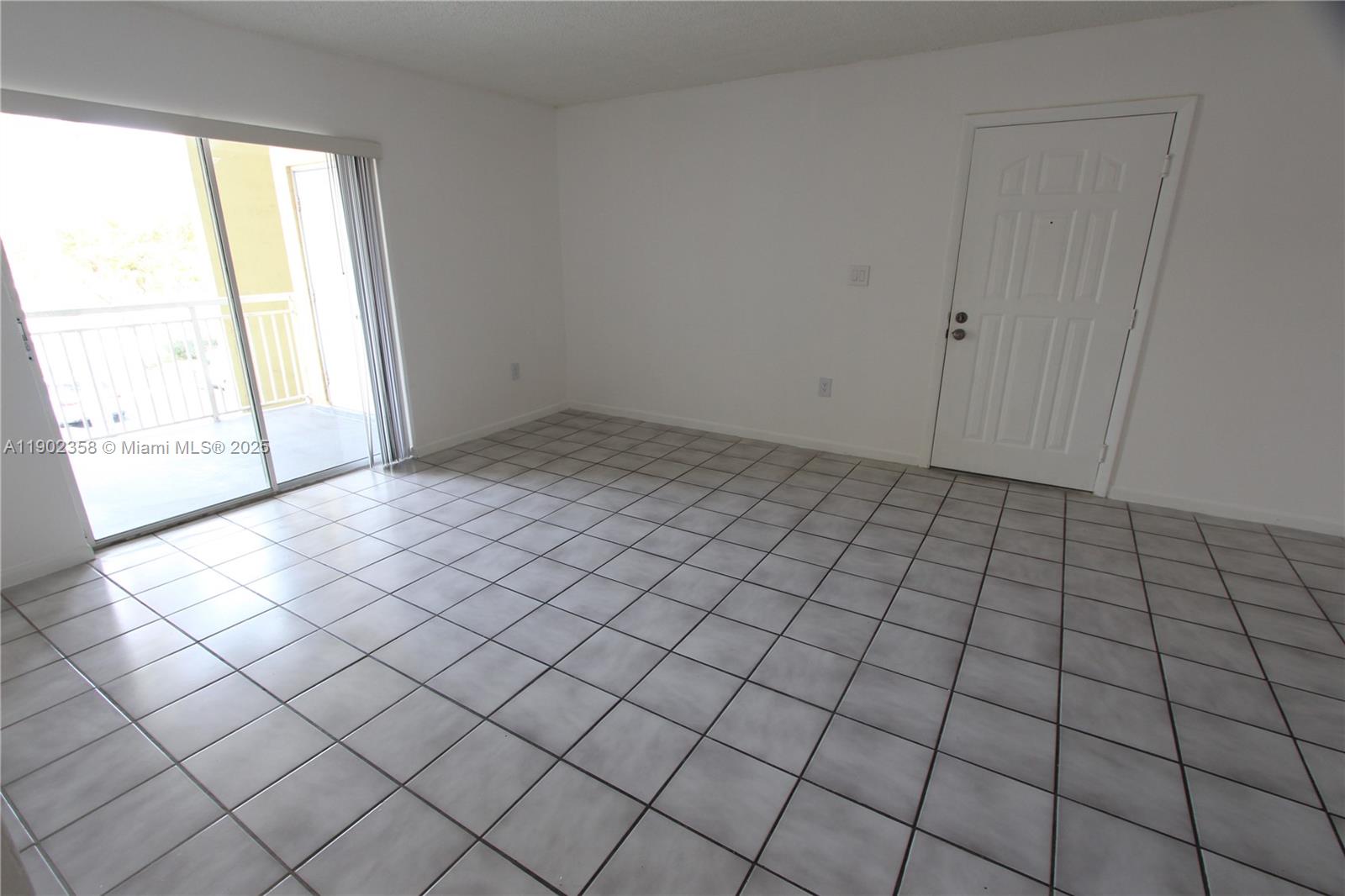 8540 Southwest 212th Street, Unit 203 Cutler Bay, FL 33189 - Photo 8 of 29 an empty room with windows