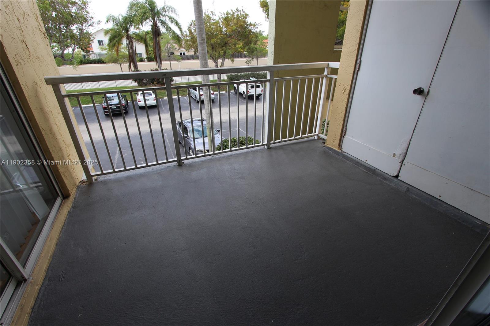 8540 Southwest 212th Street, Unit 203 Cutler Bay, FL 33189 - Photo 10 of 29 a view of a balcony with wooden floor