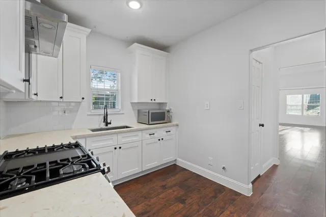a kitchen with cabinets appliances and a window