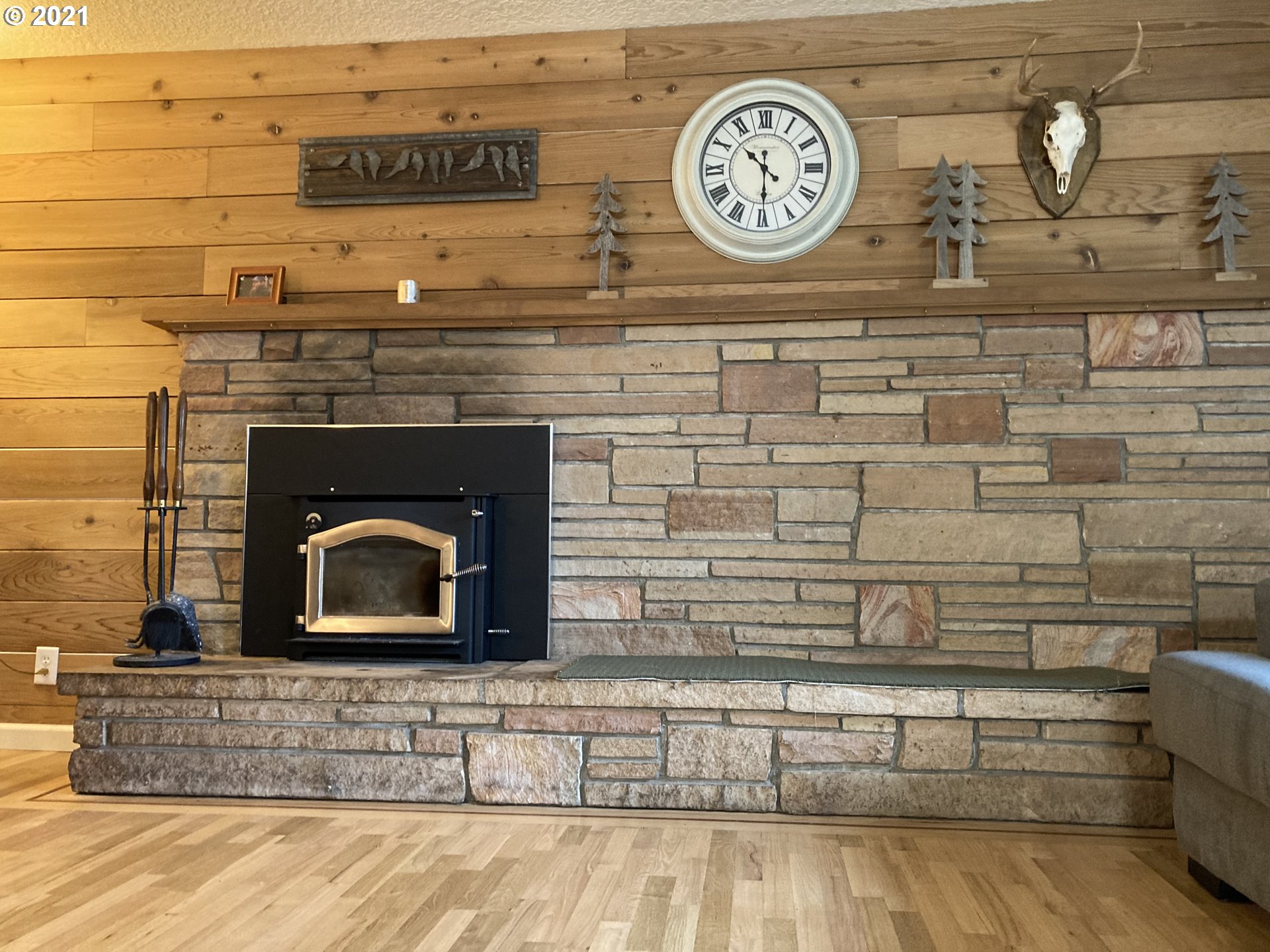 5871 Thurston Road Springfield, OR 97478 - Photo 14 of 28 a fireplace with a clock on the wall