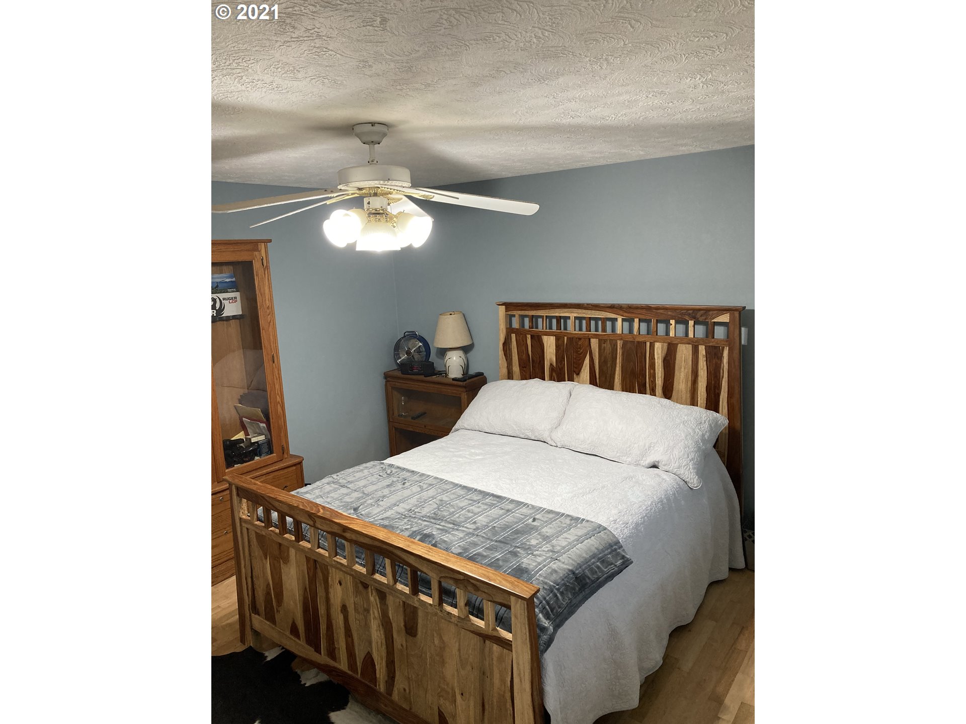 5871 Thurston Road Springfield, OR 97478 - Photo 3 of 28 a bedroom with a bed and a chandelier