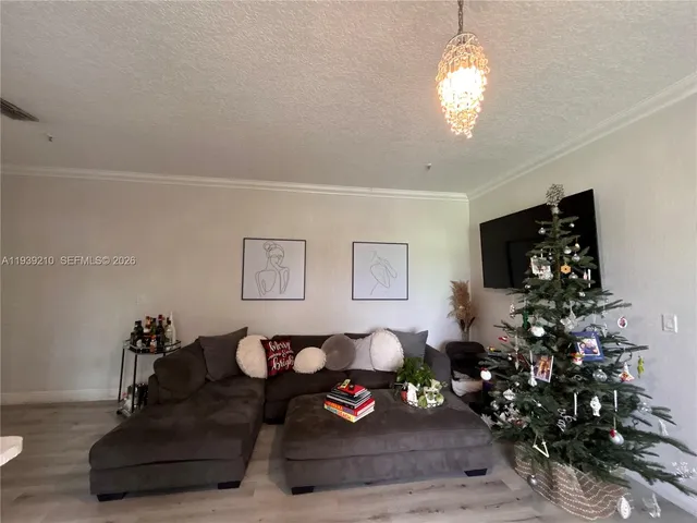 a living room with furniture and flowers
