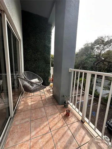 a view of a patio with a chair and the potted plant