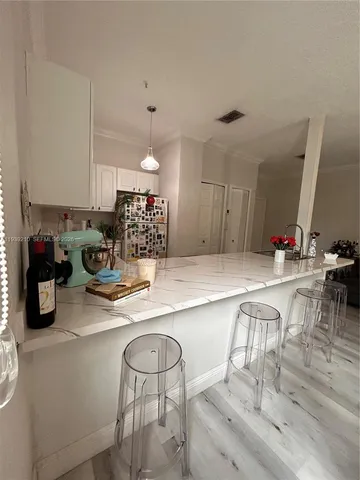 a kitchen with sink and cabinets