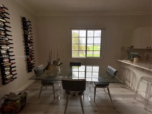 a living room with furniture a chandelier and a window