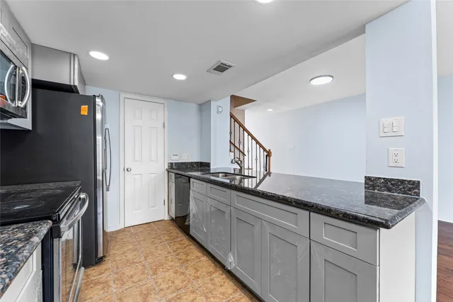 a view of room with window ceiling fan and hardwood floor