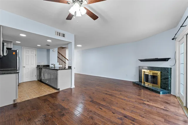 a kitchen with stainless steel appliances granite countertop a stove a sink and a refrigerator