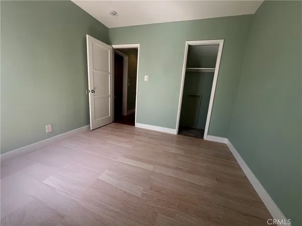 an empty room with closet and bathroom