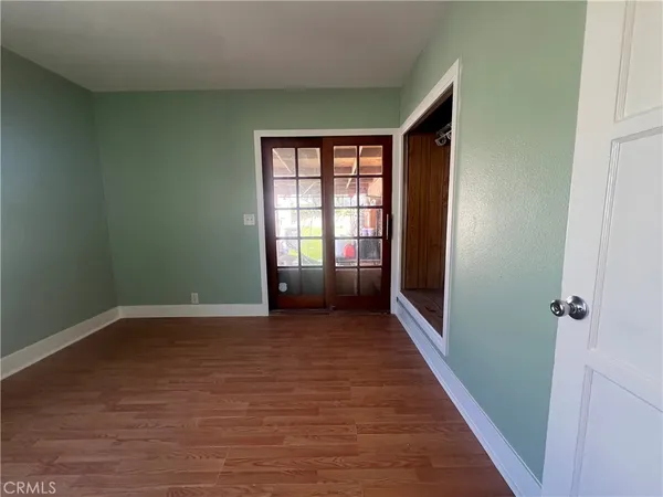 a view of hallway with stairs and wooden floor