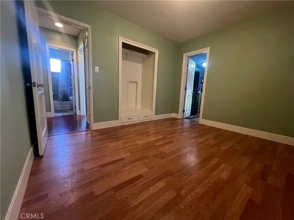 a view of a room with wooden floor