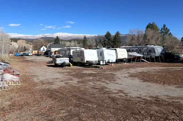 a living room with furniture a desk and chair with wooden floor