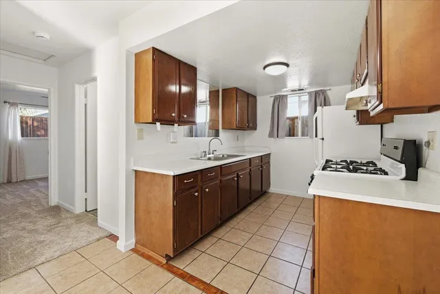 a spacious bathroom with a sink mirror and cabinets