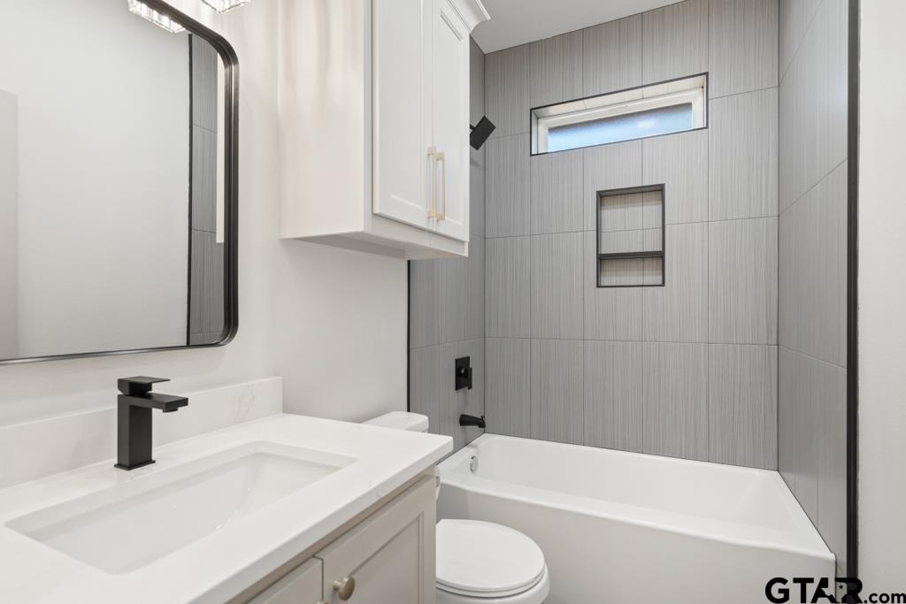 15837 Stillwaters Lindale, TX 75771 - Photo 26 of 32 a bathroom with a sink a toilet and bathtub