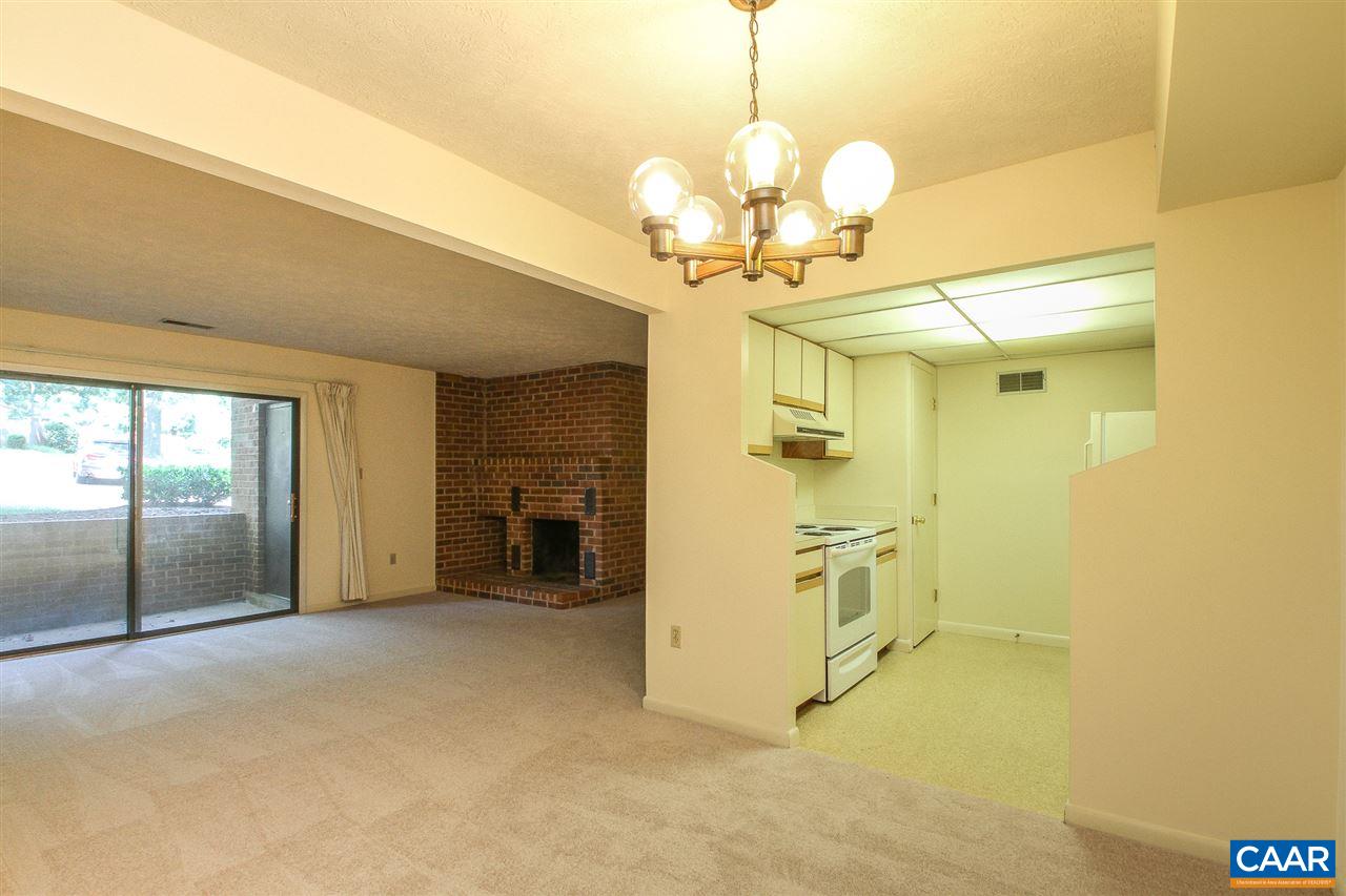 130 Turtle Creek Road, Unit 4 Charlottesville, VA 22901 - Photo 3 of 13 a view of a livingroom with a chandelier and kitchen view