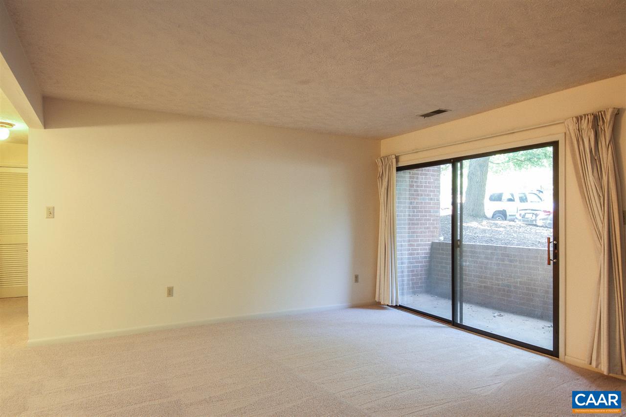130 Turtle Creek Road, Unit 4 Charlottesville, VA 22901 - Photo 4 of 13 an empty room with sliding glass door
