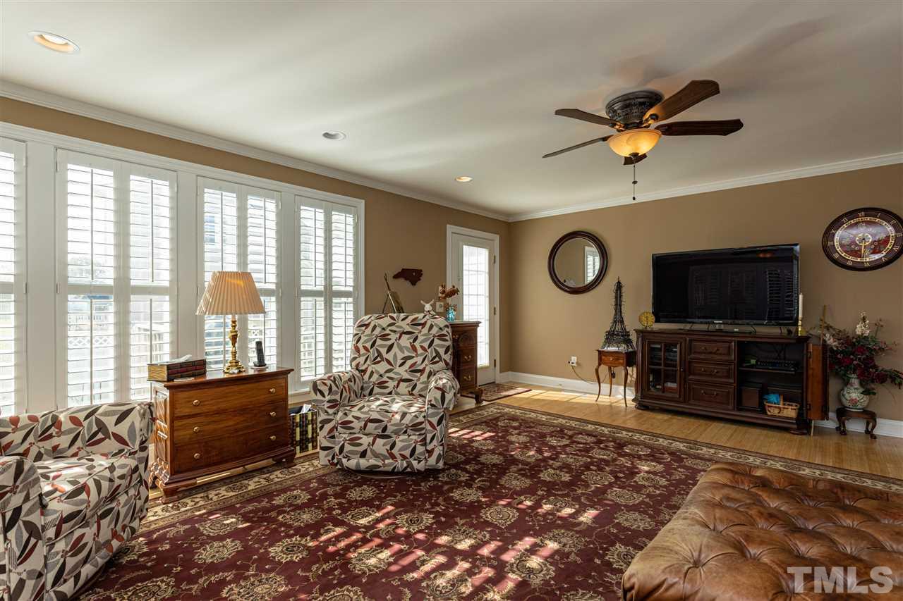 1008 Red Brick Road Garner, NC 27529 - Photo 14 of 30 a living room with furniture a flat screen tv and a large window