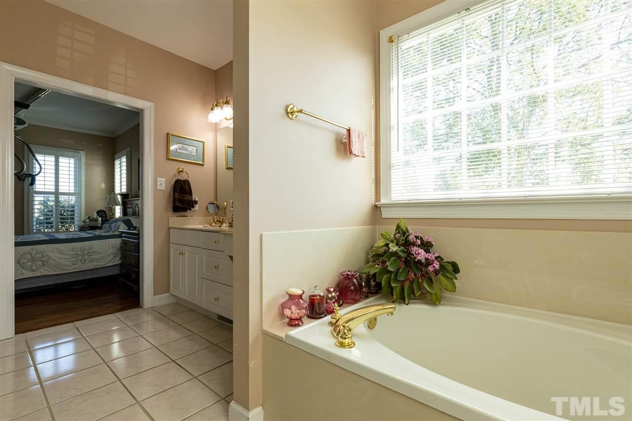 1008 Red Brick Road Garner, NC 27529 - Photo 22 of 30 a bathroom with a tub a potted plant and a sink