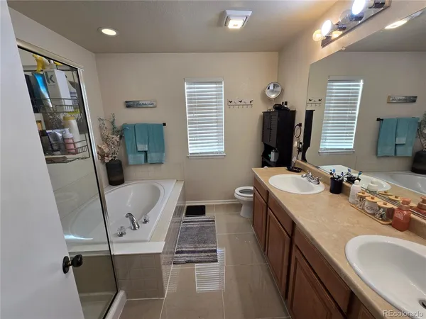 a bathroom with double vanity sink and two mirror