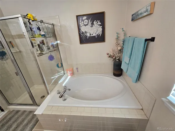 a bath tub sitting next to a white sink and vanity
