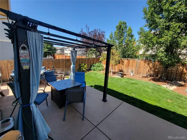 a view of porch with a table and chairs