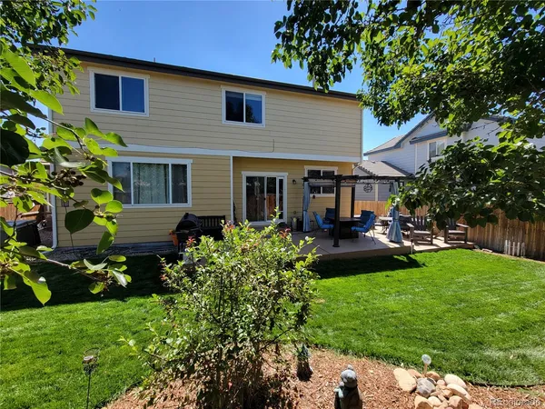 a front view of a house with patio and garden