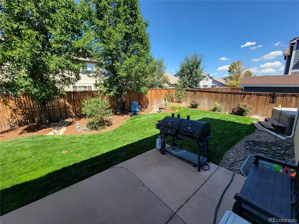 a view of backyard with seating area and green space