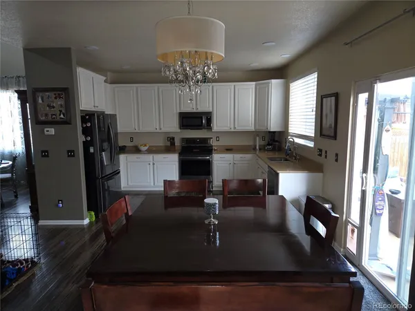 a kitchen with kitchen island granite countertop a sink stainless steel appliances and cabinets