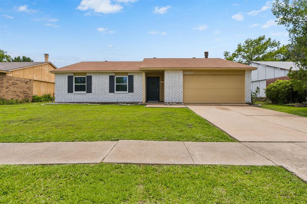 5620 Perrin Street The Colony, TX 75056 - Photo 25 of 31 a view of a yard in front of a house with large windows