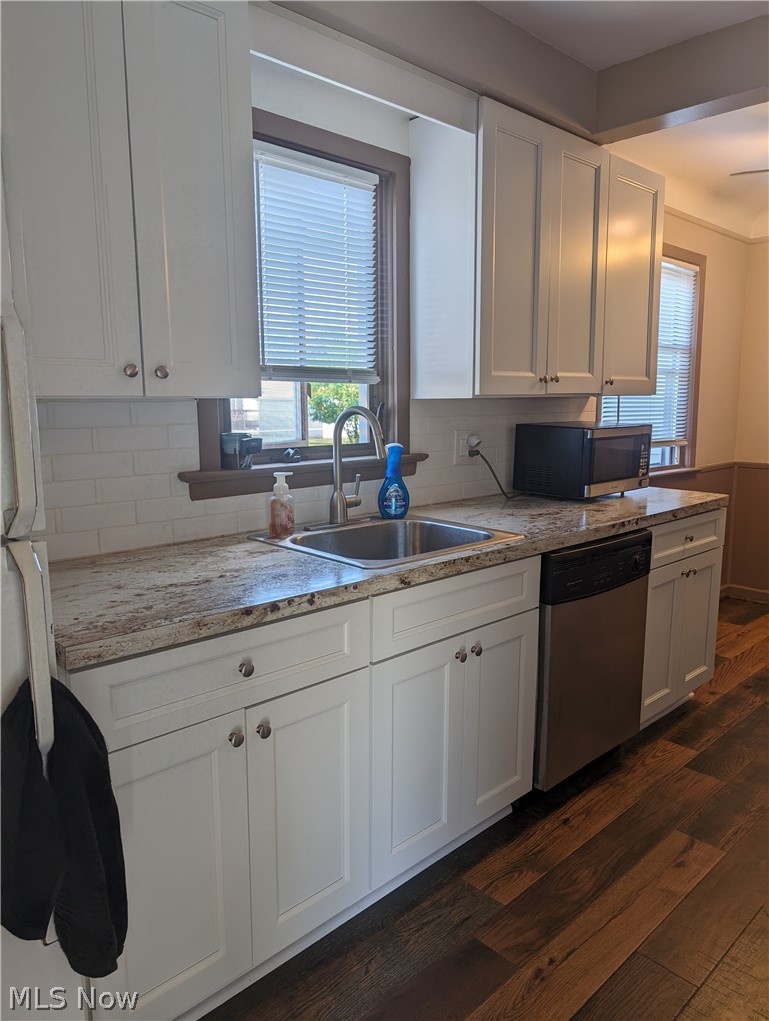 30213 Barjode Road Willowick, OH 44095 - Photo 2 of 20 Kitchen featuring stainless steel appliances, tasteful backsplash, white cabinetry, dark wood-type flooring, and sink