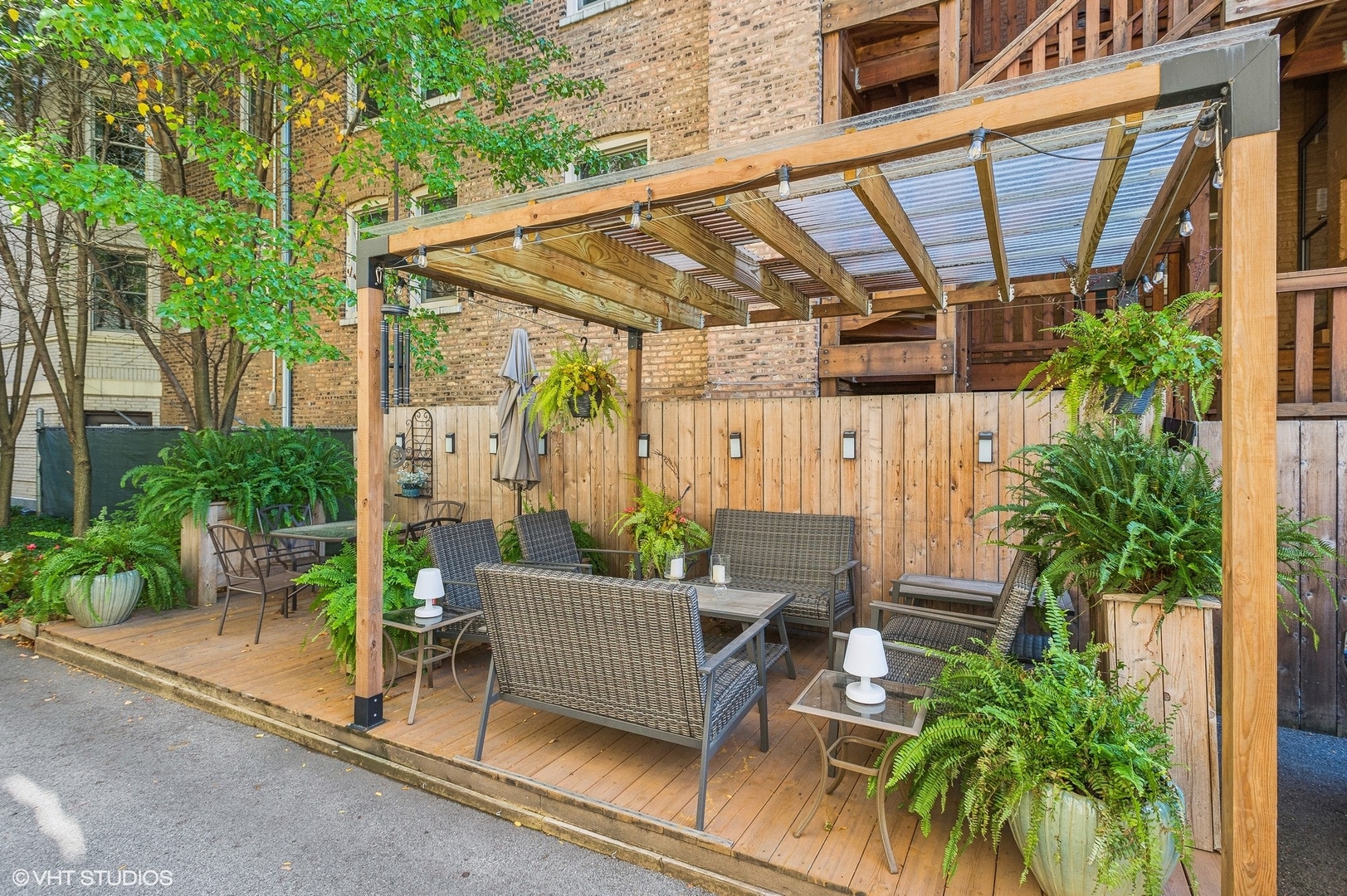 443 West Aldine Avenue, Unit 3 Chicago, IL 60657 - Photo 18 of 19 a view of a patio with table and chairs potted plants and palm tree