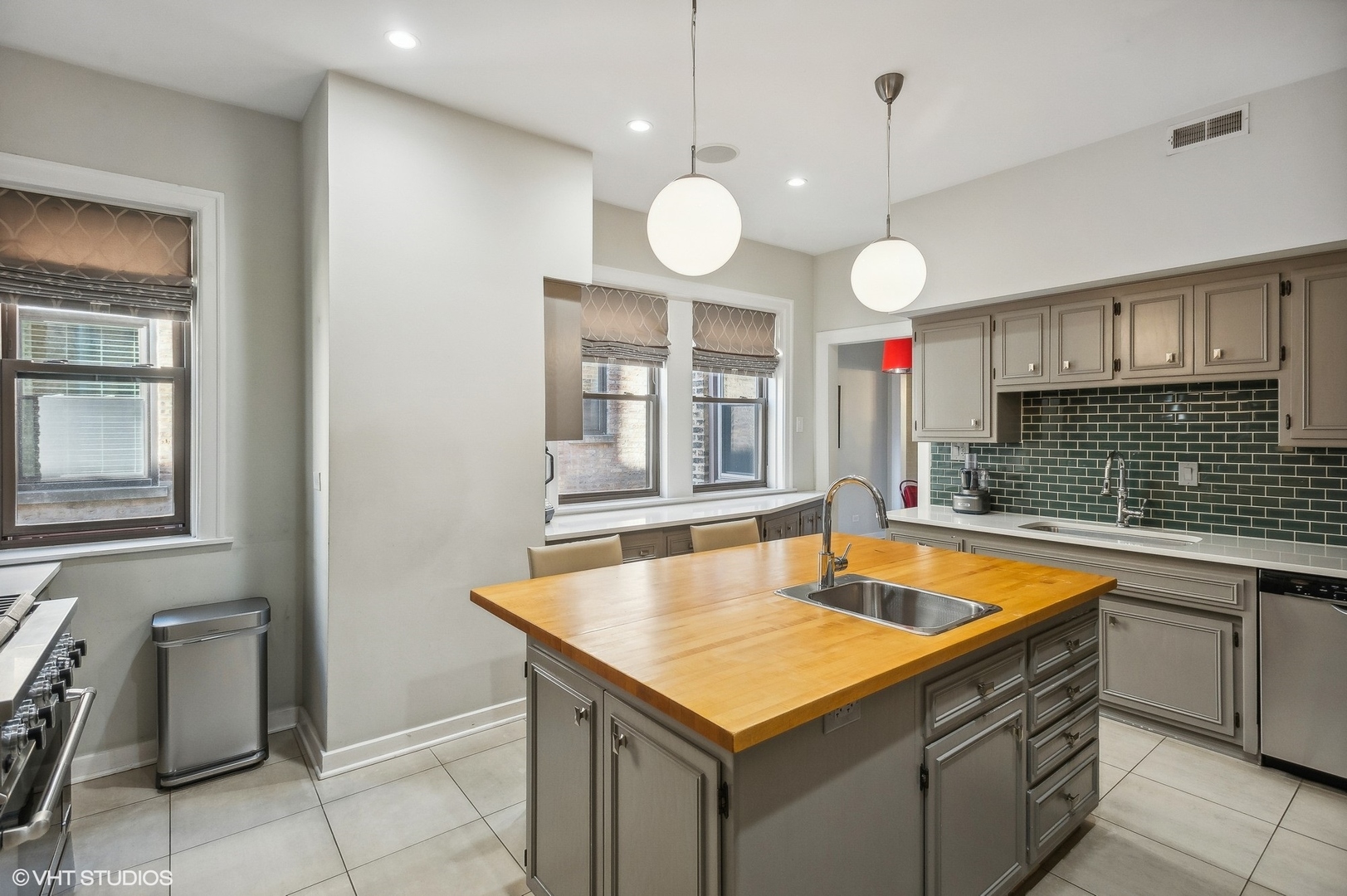 443 West Aldine Avenue, Unit 3 Chicago, IL 60657 - Photo 10 of 19 a kitchen with a refrigerator a sink and dishwasher with wooden cabinets